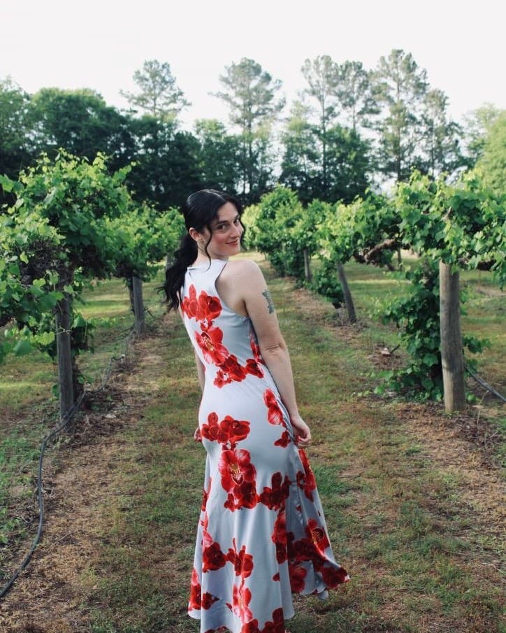 Kirsten, the photographer behind Kirsten Blair Co Photography, in a vineyard