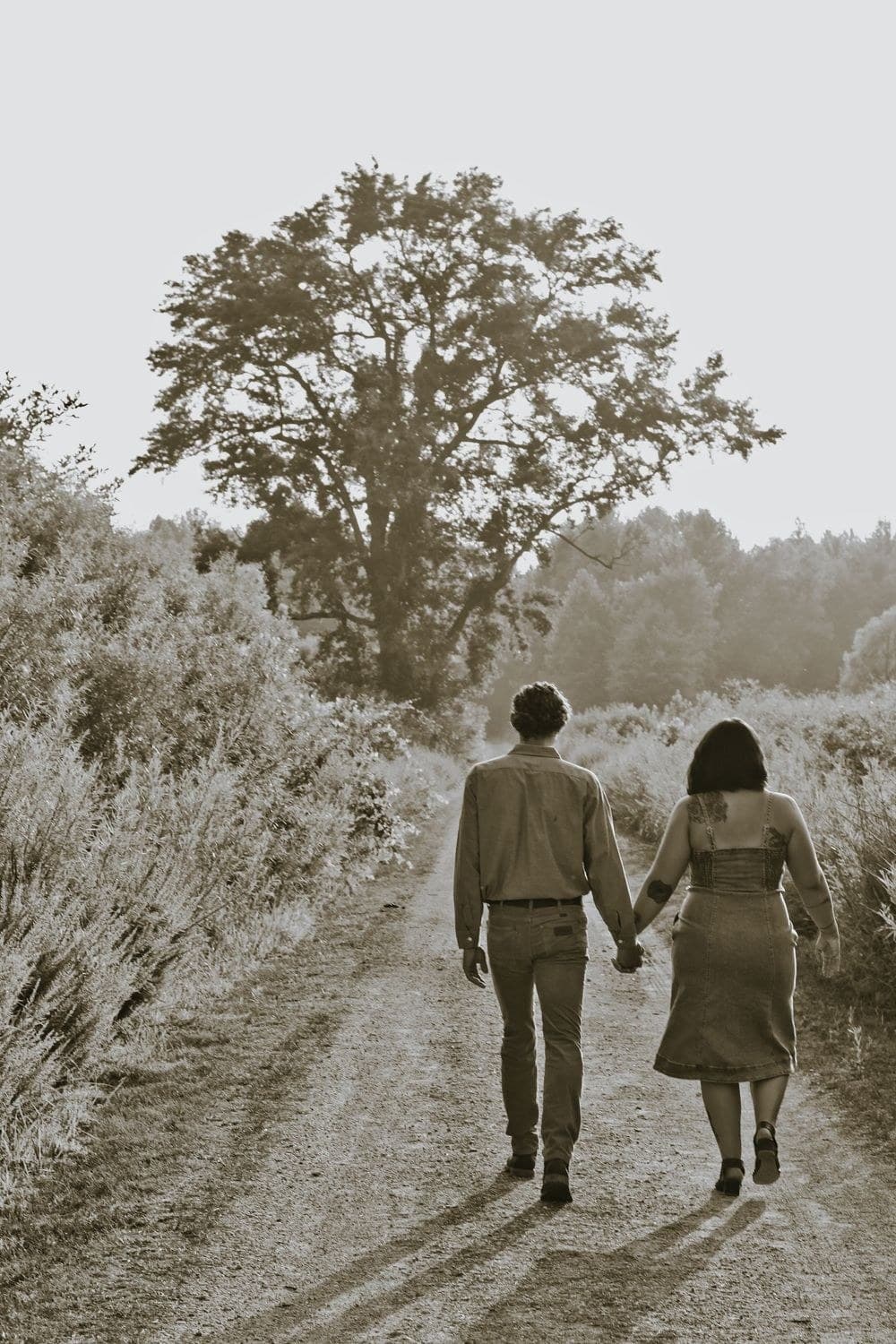Couple walking hand in hand down a quiet path