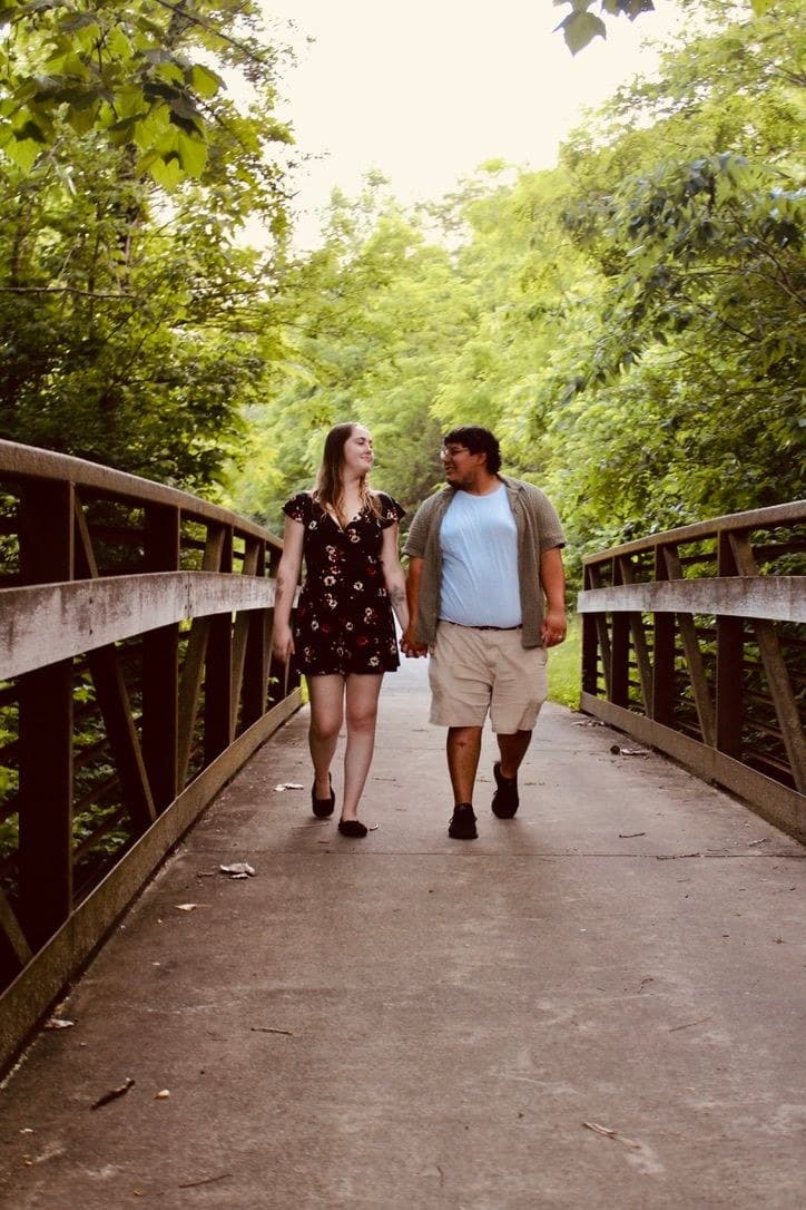Couple crossing the footbridge hand in hand
